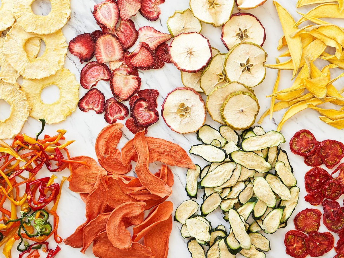 Dried vegetables resting on a square mesh belt in a food drying line