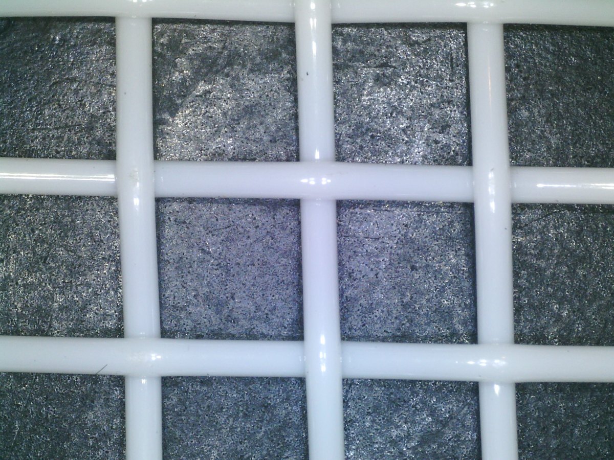 Electron microscope close-up of white polyester plain weave square mesh